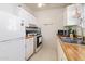 Functional kitchen with white appliances, butcher block countertops, and stainless steel sink at 417 W Sunset Dr, Mammoth, AZ 85618