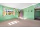 Cozy living room with carpet, green walls, a window with curtains and a garden view at 417 W Sunset Dr, Mammoth, AZ 85618