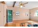 Cozy living room with wood floors, ceiling fan, and natural light from two windows at 417 W Sunset Dr, Mammoth, AZ 85618