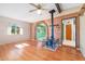 Spacious living room featuring hardwood floors, a brick archway, and a cozy wood burning stove at 417 W Sunset Dr, Mammoth, AZ 85618