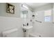 Clean bathroom with pedestal sink, updated fixtures, and tiled walk-in shower at 4235 N 16Th Dr, Phoenix, AZ 85015