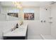 Bright bathroom featuring a double sink vanity and a tiled walk-in shower at 4235 N 16Th Dr, Phoenix, AZ 85015