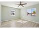 Bright bedroom with neutral tones, ceiling fan, and two windows at 4235 N 16Th Dr, Phoenix, AZ 85015