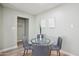 Dining area with glass table, gray chairs, modern wall art, and light wood-look floors at 4235 N 16Th Dr, Phoenix, AZ 85015