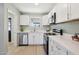 Bright kitchen with white cabinetry, stainless steel appliances, and neutral countertops at 4235 N 16Th Dr, Phoenix, AZ 85015