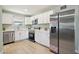 Modern kitchen with white cabinets, stainless steel appliances, and quartz countertops at 4235 N 16Th Dr, Phoenix, AZ 85015