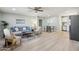 Spacious living room with gray sofa, dining area, stainless steel refrigerator, and modern flooring at 4235 N 16Th Dr, Phoenix, AZ 85015