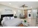 Comfortable main bedroom featuring a ceiling fan, ensuite bathroom, and seating area at 4235 N 16Th Dr, Phoenix, AZ 85015