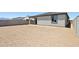 Large backyard with potential for landscaping, featuring a block fence and covered patio at 4513 W 95Th Dr, Tolleson, AZ 85353