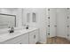 Contemporary bathroom with double vanity, quartz countertops, and stylish black fixtures at 4513 W 95Th Dr, Tolleson, AZ 85353