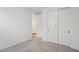 Bright bedroom featuring plush carpet, closet, and open door to the rest of the home at 4513 W 95Th Dr, Tolleson, AZ 85353