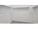 Walk-in closet with white walls and carpet flooring, ideal for storage and organization at 4513 W 95Th Dr, Tolleson, AZ 85353