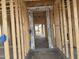 View of the framed entryway of the house with visible wall studs and concrete flooring at 4513 W 95Th Dr, Tolleson, AZ 85353