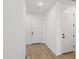 Bright entryway showcasing wood-look tile flooring and a modern white door at 4513 W 95Th Dr, Tolleson, AZ 85353
