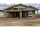 Framing of a partially completed single-Gathering home featuring an attached garage with a partially tiled roof at 4513 W 95Th Dr, Tolleson, AZ 85353