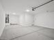Large garage space with water heater and storage for vehicles or a workshop at 4513 W 95Th Dr, Tolleson, AZ 85353
