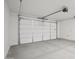 Spacious garage with clean concrete floor and insulated garage door at 4513 W 95Th Dr, Tolleson, AZ 85353