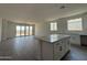 Open-concept kitchen featuring a large island and sliding glass doors to the backyard, perfect for entertaining at 4513 W 95Th Dr, Tolleson, AZ 85353