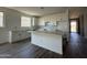 Modern kitchen featuring white cabinets, tiled floors, and ample counter space, ideal for cooking and gatherings at 4513 W 95Th Dr, Tolleson, AZ 85353