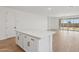 Kitchen island featuring white cabinets, drawers and light countertops at 4513 W 95Th Dr, Tolleson, AZ 85353