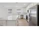 Spacious kitchen featuring stainless steel appliances, an island and white cabinets at 4513 W 95Th Dr, Tolleson, AZ 85353