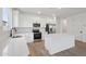 Bright kitchen showcases stainless steel appliances, island, and white cabinets at 4513 W 95Th Dr, Tolleson, AZ 85353