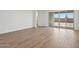 Sun-filled living area boasting elegant wood-look tile, an easy access to an outdoor living space at 4513 W 95Th Dr, Tolleson, AZ 85353