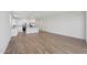 Expansive living area with an open layout, blending seamlessly with the kitchen and showcasing wood-look tile flooring at 4513 W 95Th Dr, Tolleson, AZ 85353