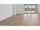 Well-lit living space with seamless outdoor access, wood-look tile flooring, and a modern, minimalist design at 4513 W 95Th Dr, Tolleson, AZ 85353