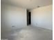 Unfinished room features an entrance door and open space, ready for customization at 4513 W 95Th Dr, Tolleson, AZ 85353