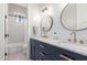 Bright bathroom featuring double sinks, granite countertops, blue cabinets and modern fixtures at 4675 S Bandit Rd, Gilbert, AZ 85297