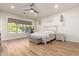 Bright bedroom featuring shiplap accent wall, hardwood floors, and a large window with a view at 4675 S Bandit Rd, Gilbert, AZ 85297