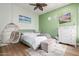 Bright bedroom with beach themed artwork and a hanging swing chair at 4675 S Bandit Rd, Gilbert, AZ 85297