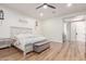 Spacious bedroom featuring shiplap accent wall, hardwood floors, and neutral decor, creating a serene retreat at 4675 S Bandit Rd, Gilbert, AZ 85297