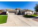 Beautiful home featuring a three-car garage, manicured lawn, and modern architectural design at 4675 S Bandit Rd, Gilbert, AZ 85297