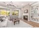 Cozy living room with brick fireplace, built-in shelves, and large windows providing natural light at 4675 S Bandit Rd, Gilbert, AZ 85297