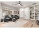 Comfortable living room with built in bookcase, ceiling fan and two recliners at 4675 S Bandit Rd, Gilbert, AZ 85297