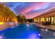 Luxury pool with built in lighting, cascading waterfall, and outdoor seating at 4675 S Bandit Rd, Gilbert, AZ 85297