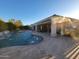 Gorgeous pool with a stone waterfall feature and misting system, creating the ultimate relaxation and entertaining space at 4675 S Bandit Rd, Gilbert, AZ 85297