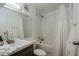 Bright bathroom featuring a shower-tub combo, neutral tiling, and a modern vanity at 4754 N 14Th St, Phoenix, AZ 85014