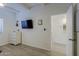 Bright bedroom featuring light wood floors, a wall-mounted TV, and a view into the adjacent room at 4754 N 14Th St, Phoenix, AZ 85014