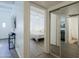 View of a bedroom with white walls, a large bed, and access to both the bathroom and hallway at 4754 N 14Th St, Phoenix, AZ 85014