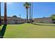 Well-maintained grassy common area with mature trees in the background with neighborhood buildings at 4754 N 14Th St, Phoenix, AZ 85014