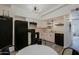 Spacious kitchen featuring modern appliances, white cabinets, and light wood flooring for a clean, functional space at 4754 N 14Th St, Phoenix, AZ 85014