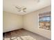 Bright bedroom featuring neutral walls and carpet with backyard views from the large window at 48822 N Roughrider Rd, New River, AZ 85087