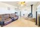 Spacious living room with tile flooring, a ceiling fan, and a wood-burning stove at 48822 N Roughrider Rd, New River, AZ 85087