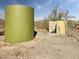 Utility: Outdoor well system next to a large water storage tank at 48822 N Roughrider Rd, New River, AZ 85087