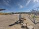 Picture of yard with gravel, playground, water well and distant views at 48822 N Roughrider Rd, New River, AZ 85087