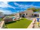 Inviting backyard oasis complete with a pool, artificial grass, and a covered patio perfect for outdoor living at 4887 E Armor St, Cave Creek, AZ 85331