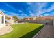 Expansive backyard with a sparkling pool, artificial lawn, and easy access to the home's outdoor living spaces at 4887 E Armor St, Cave Creek, AZ 85331